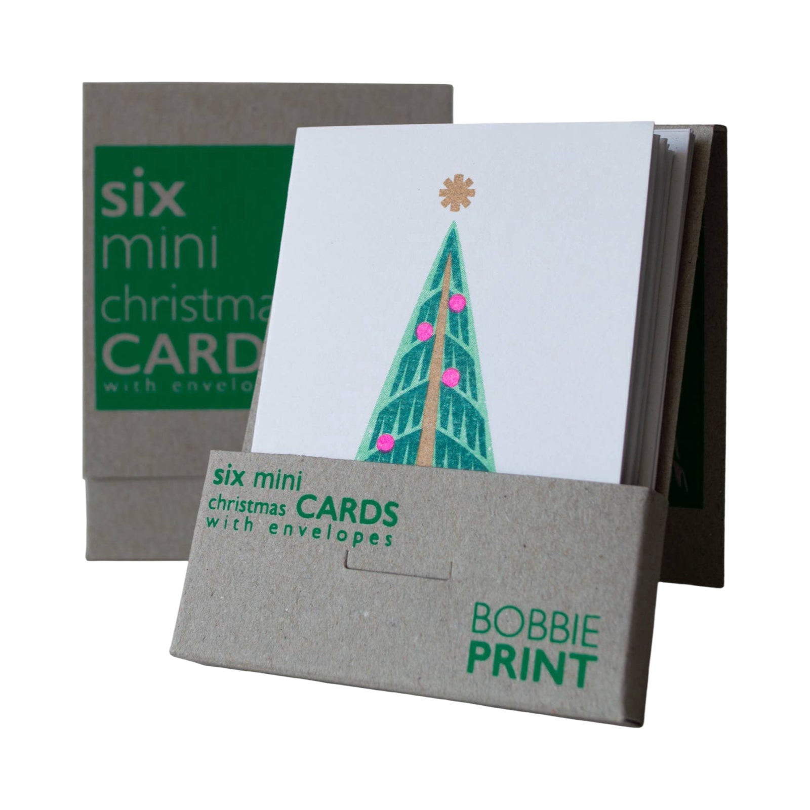 Christmas card with a green Christmas tree with pink baubles and a gold star inside a open brown card box