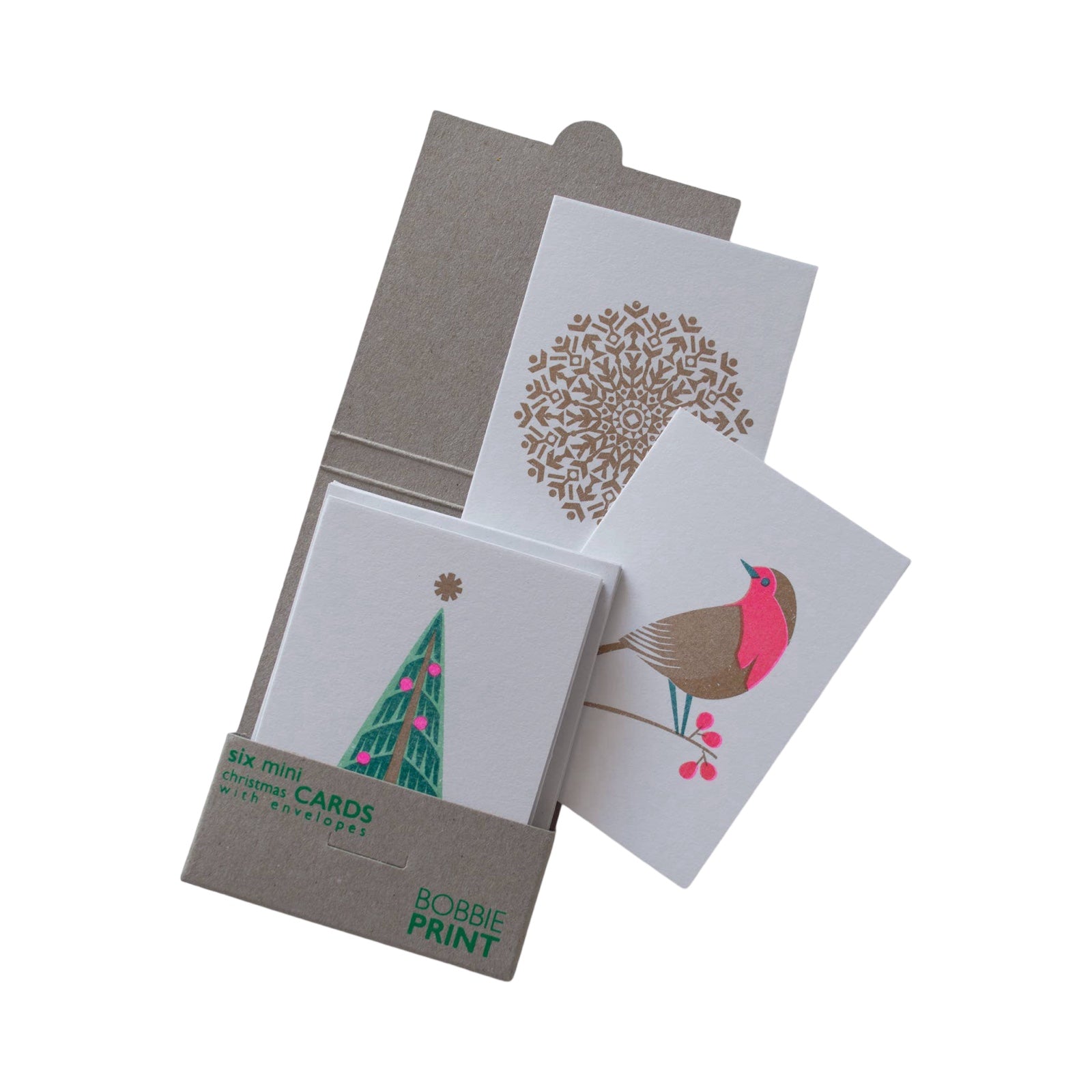 A pack of risograph printed Christmas cards showing 1 card with a large gold snowflake, 1 with a colourful robin and 1 with a green Christmas tree with pink baubles and a gold star