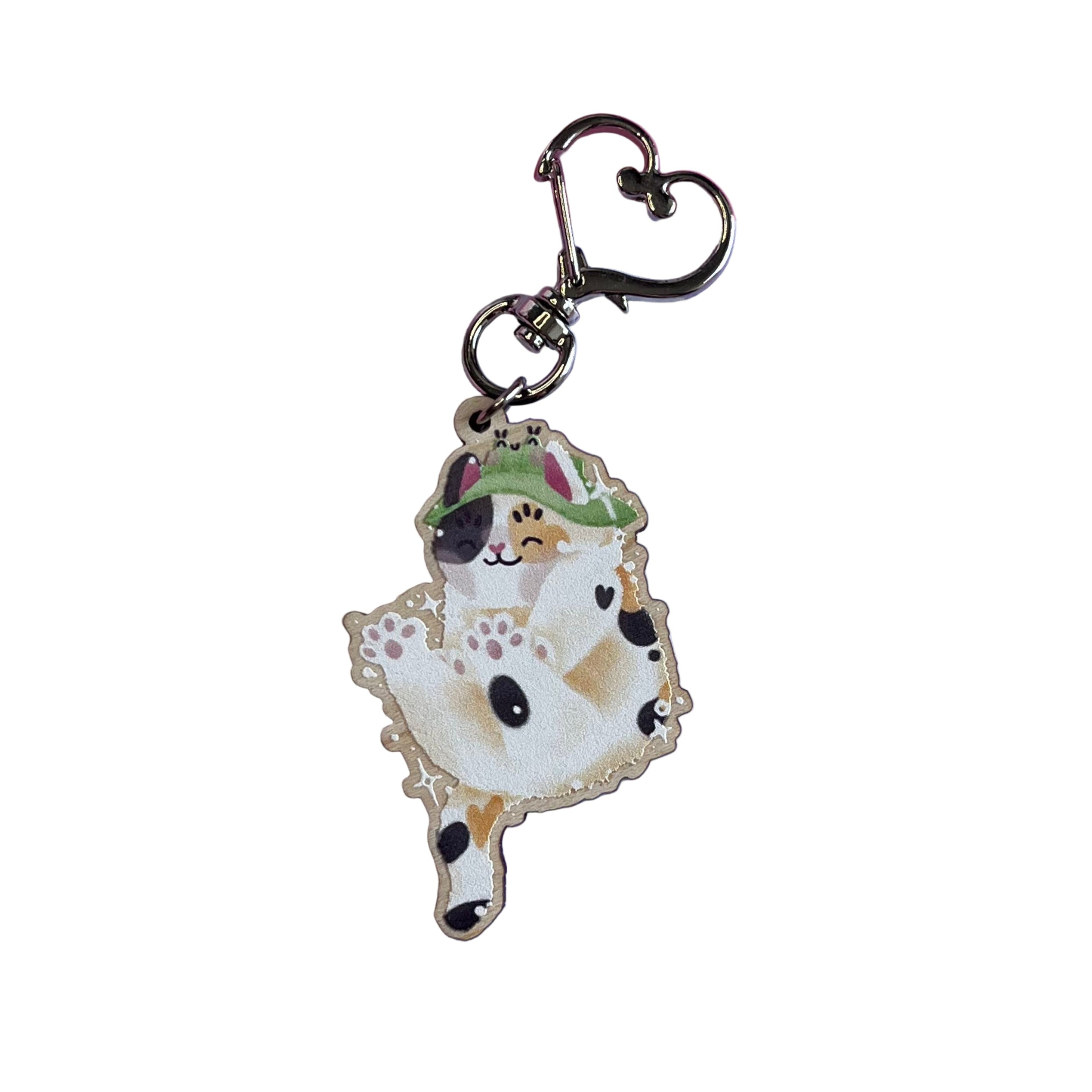 Wooden keyring with silver, heart-shaped lobster clasp. Bucket the Frog Bucket Hat wearing calico cat is doing a big stretch in this keyring design. This keyring is printed onto 4mm thick responsibly sourced European birch plywood.
