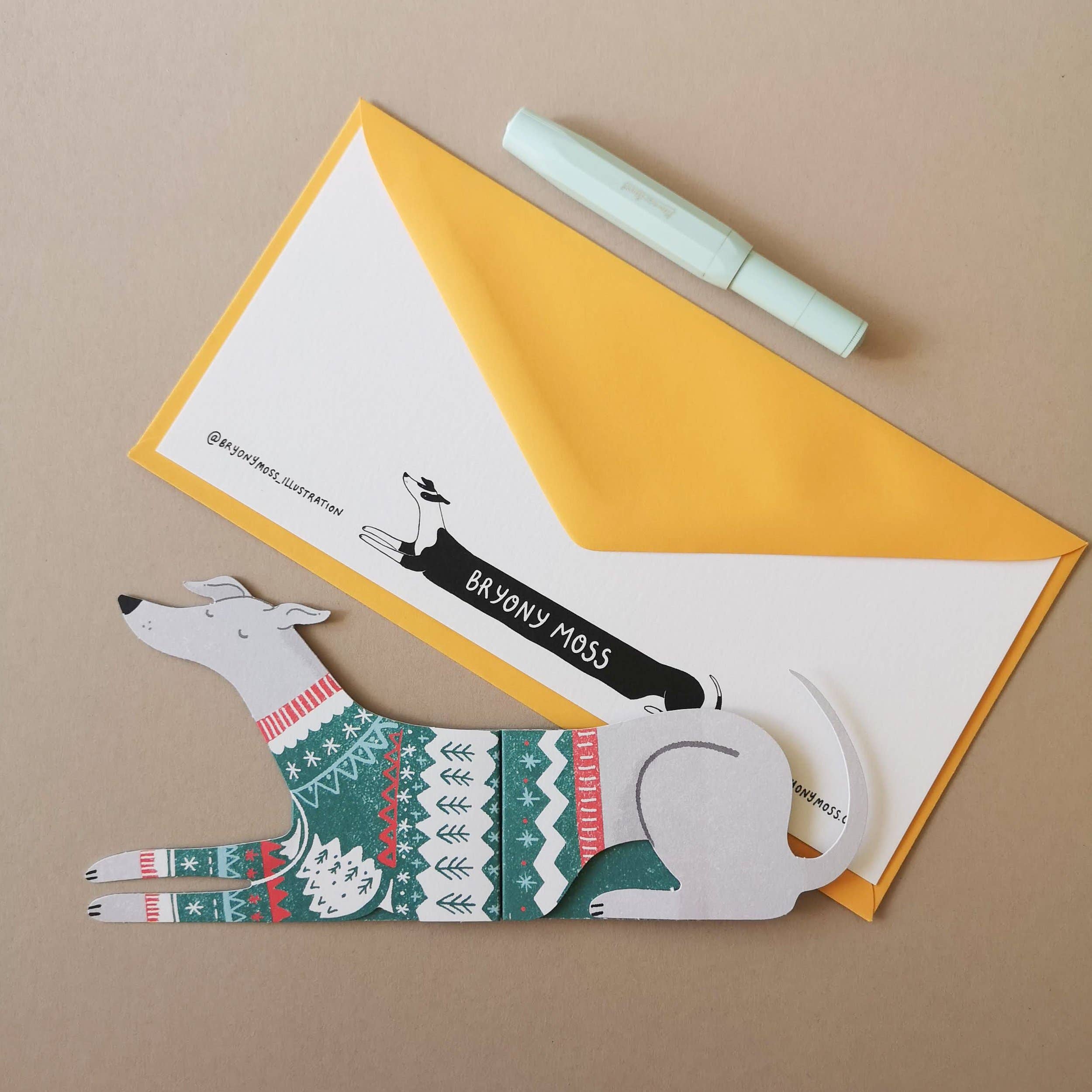 Dog-shaped card with a sweater design on a yellow envelope.