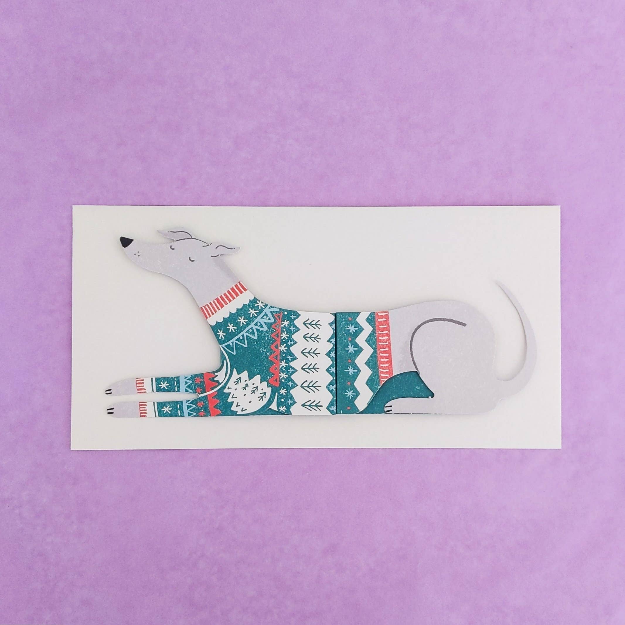 Cartoon dog wearing a sweater on a white card with a purple background.