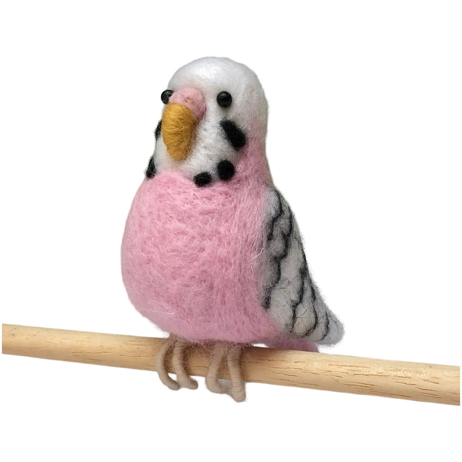 A pink felted budgie sitting on a cane.