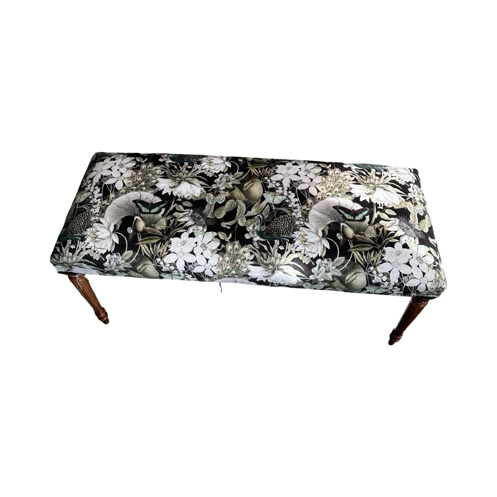 Floral patterned bench on a white background.