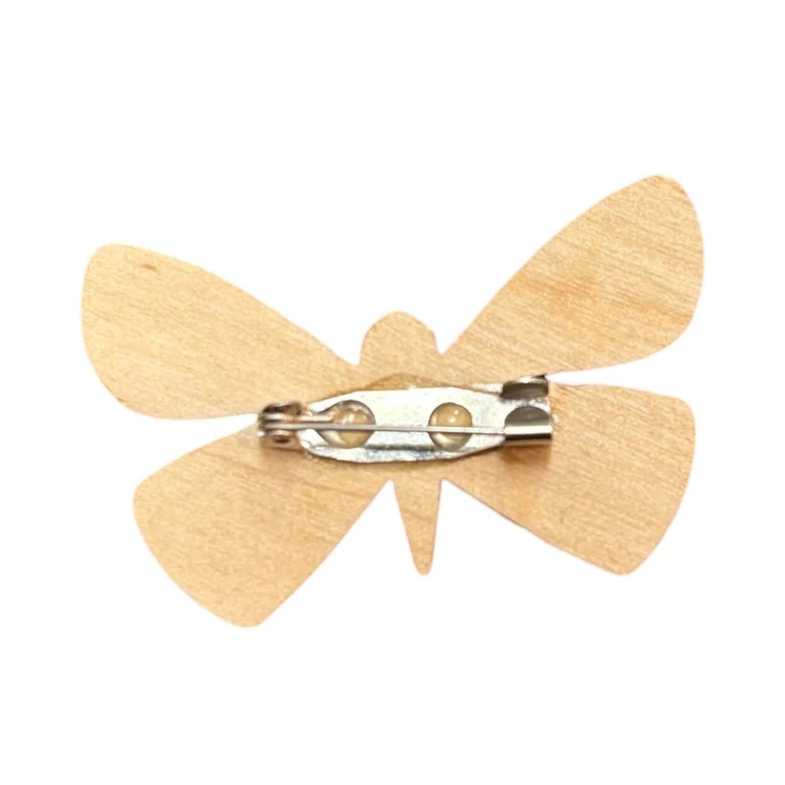 The back of a wooden butterfly-shaped brooch with a silver clasp.