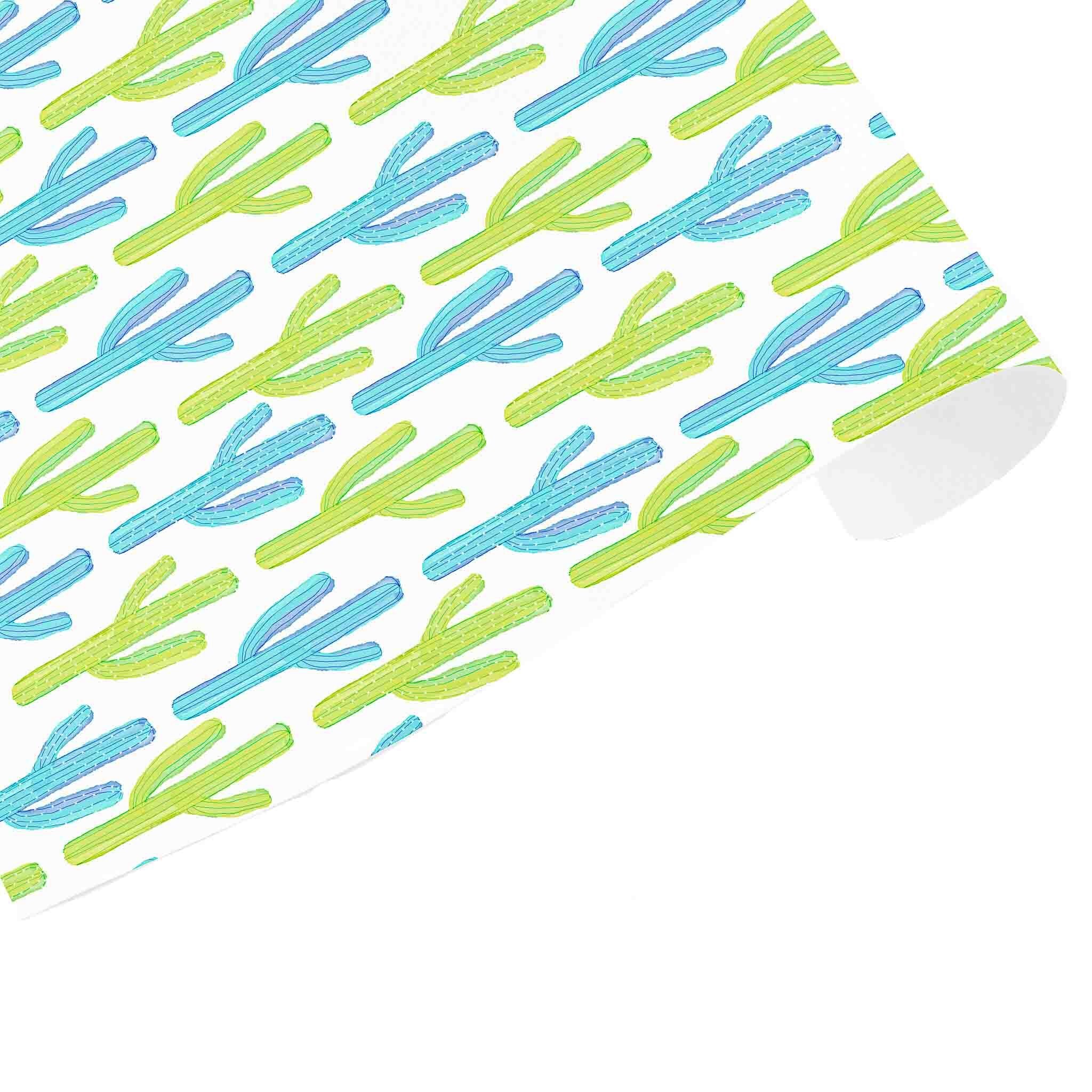 A sheet of wrapping paper with a geometric cactus pattern in blue and green colors on a white background.