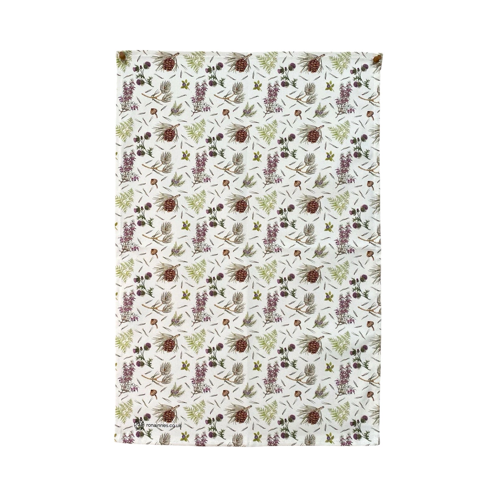 A tea towel featuring illustrations of thistles and acorns against an off-white background.