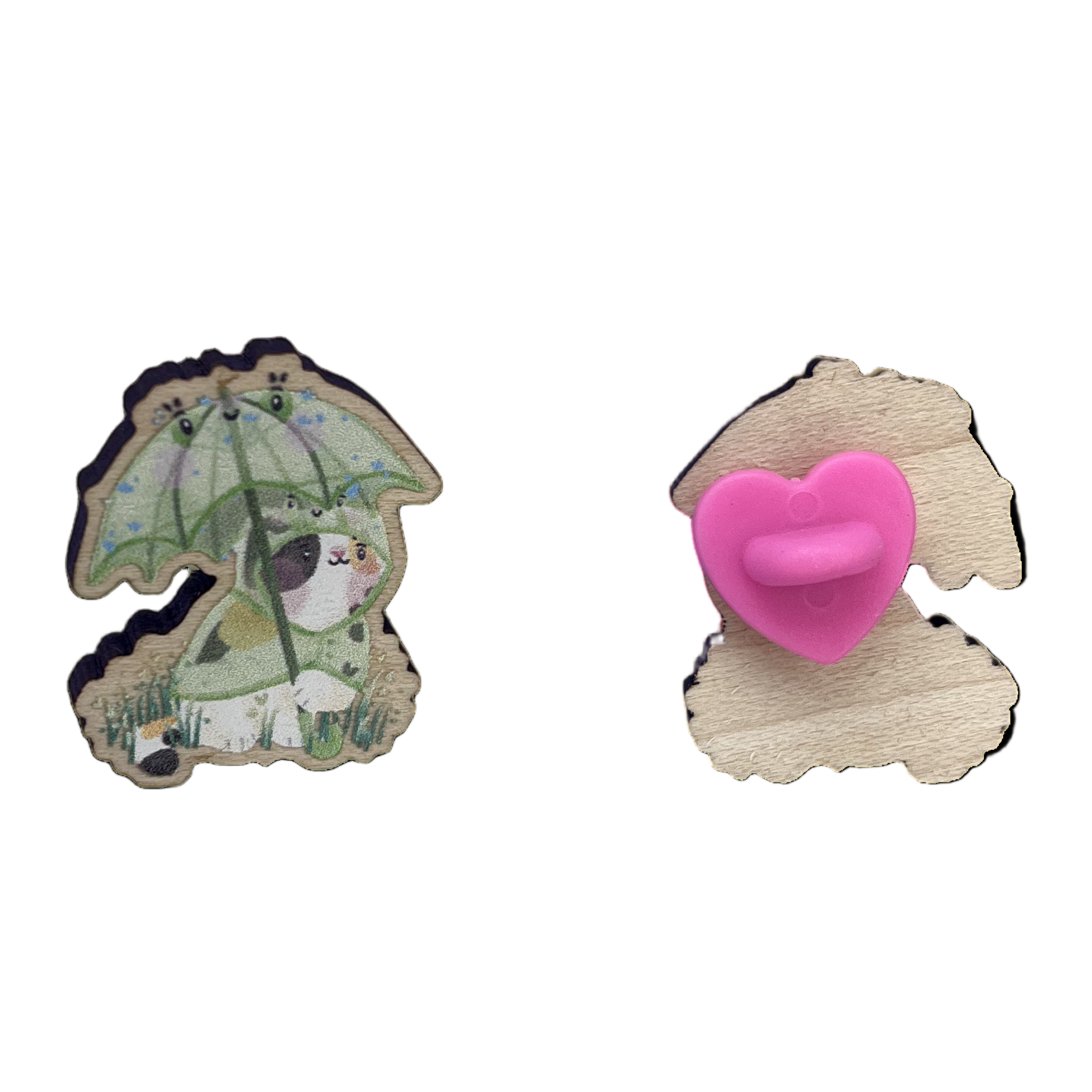 Wooden pin badge of a calico cat wearing a frog raincoat, holding a matching frog umbrella - front (left), back (right)