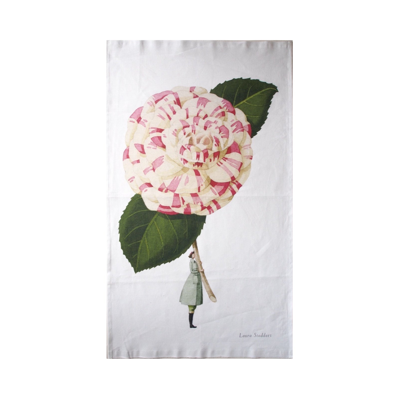 A white tea towel featuring an illustration of a lady dressed in a pale blue jacket and black boots holding a giant camellia flower.