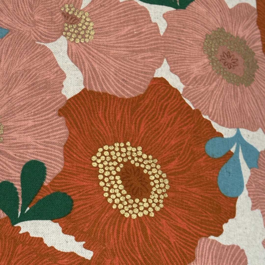 Orange and coral floral fabric with green leaves and gold detail