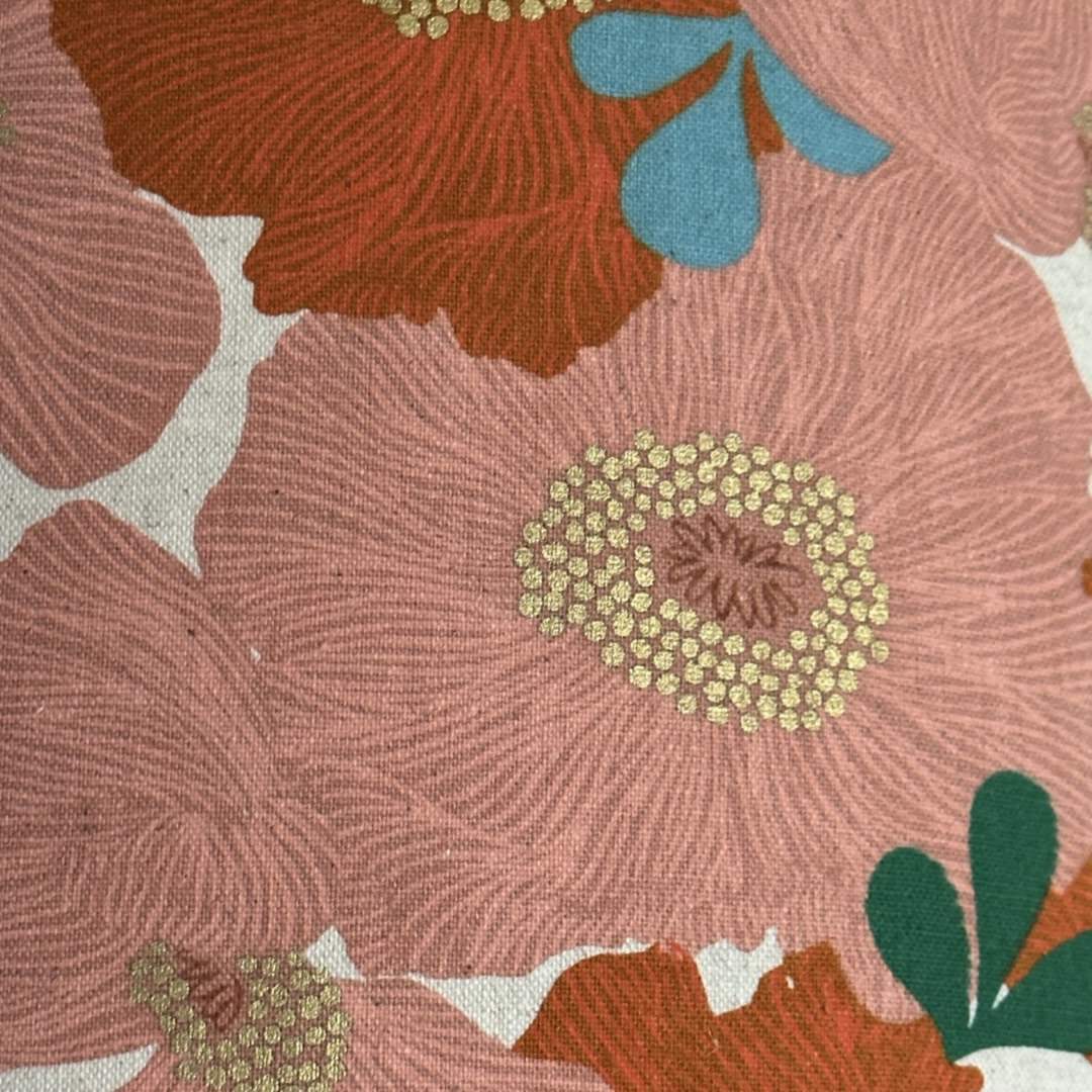 Orange and coral floral fabric with green leaves and gold detail