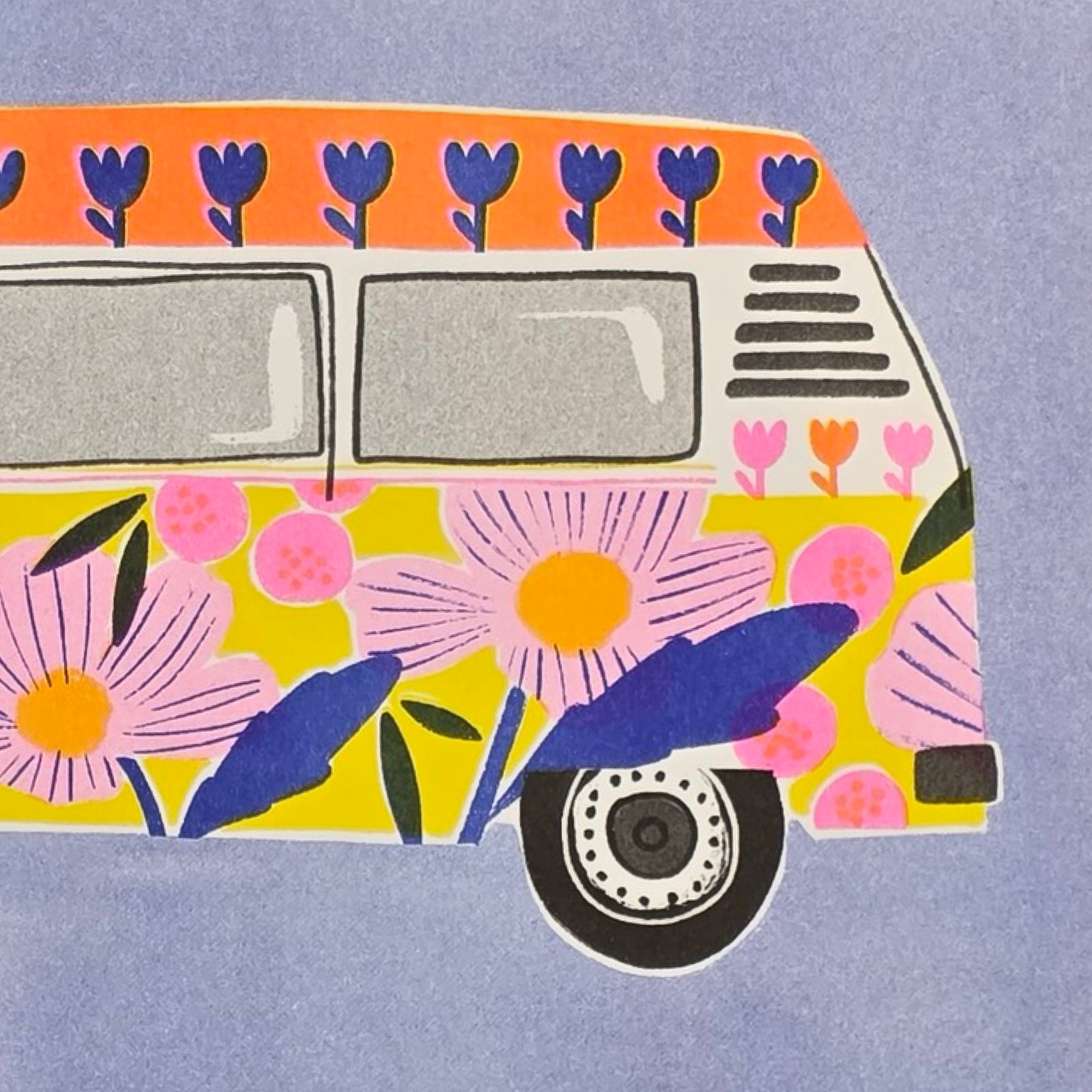 This print features an illustration of a colourful floral campervan against a blue background. 