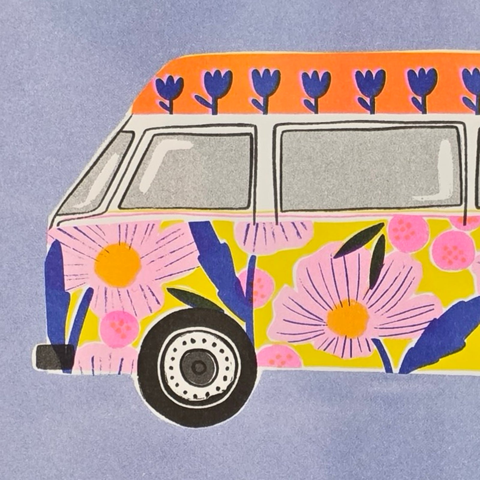This print features an illustration of a colourful floral campervan against a blue background. 