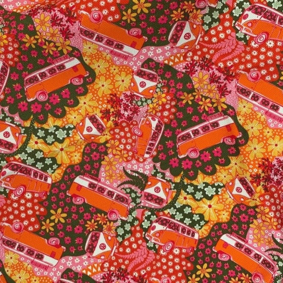 Tea towel with a repeat pattern illustration of an orange and cream VW campervan from the front, the side and angled against a floral backdrop.