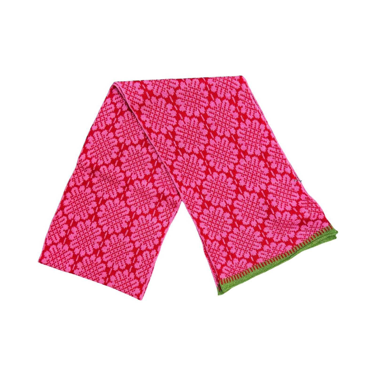 A 100% lambswool knitted scarf with a pink daisy pattern against a red background with contrasting green edges.