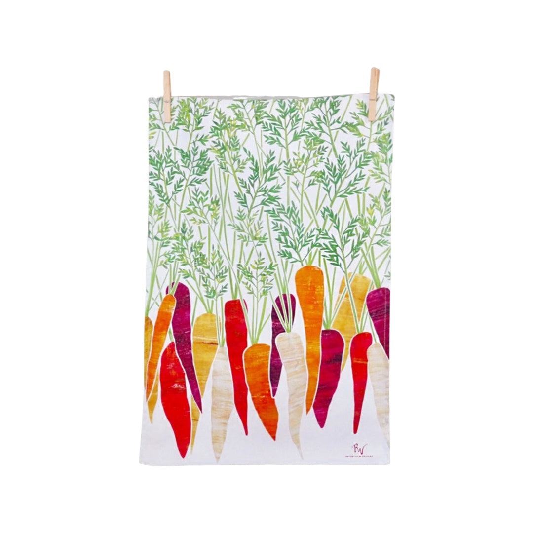Carrot tea towel featuring purple, orange and cream carrots with green leaves on a white background.
