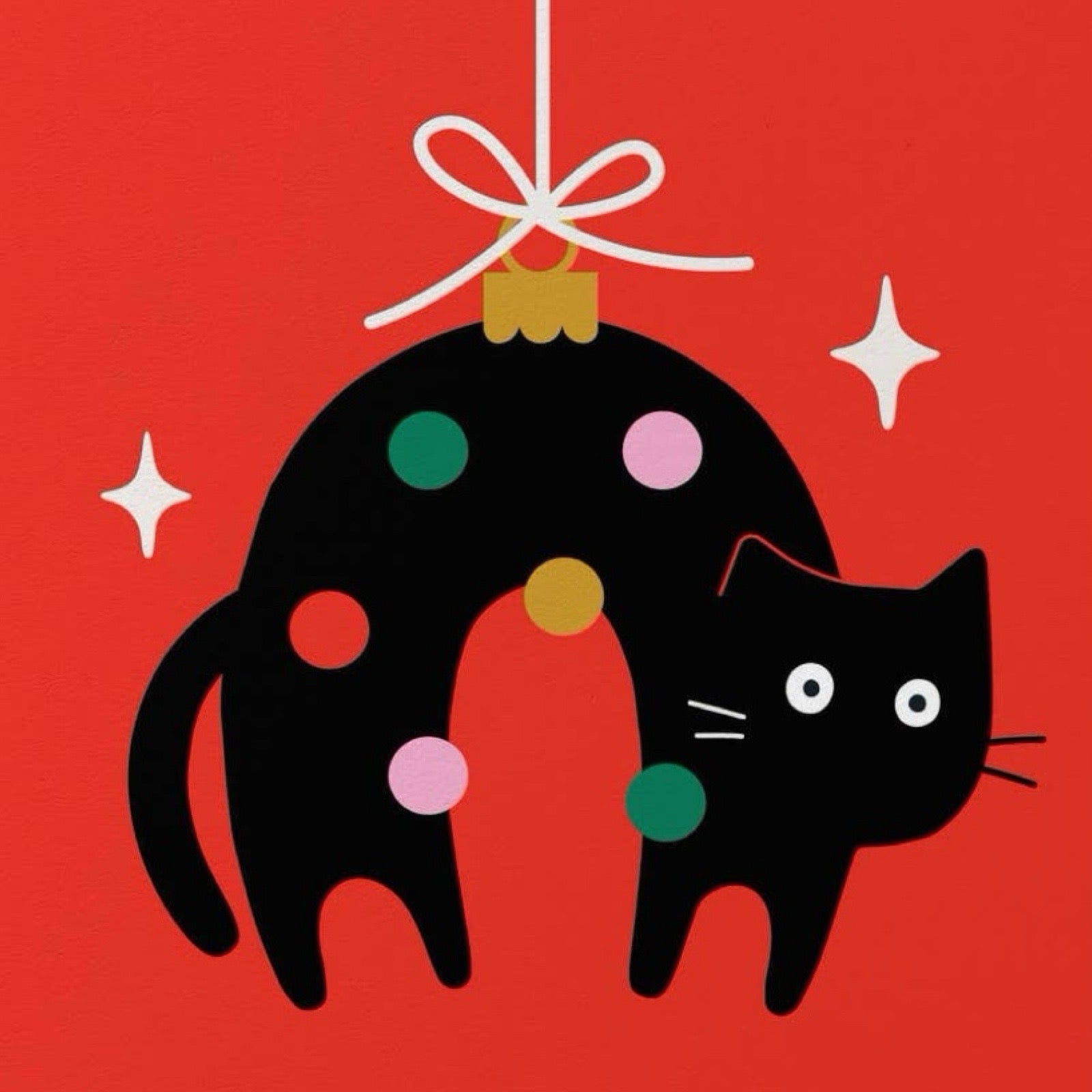 Christmas card featuring a black cat hanging like a Christmas bauble.