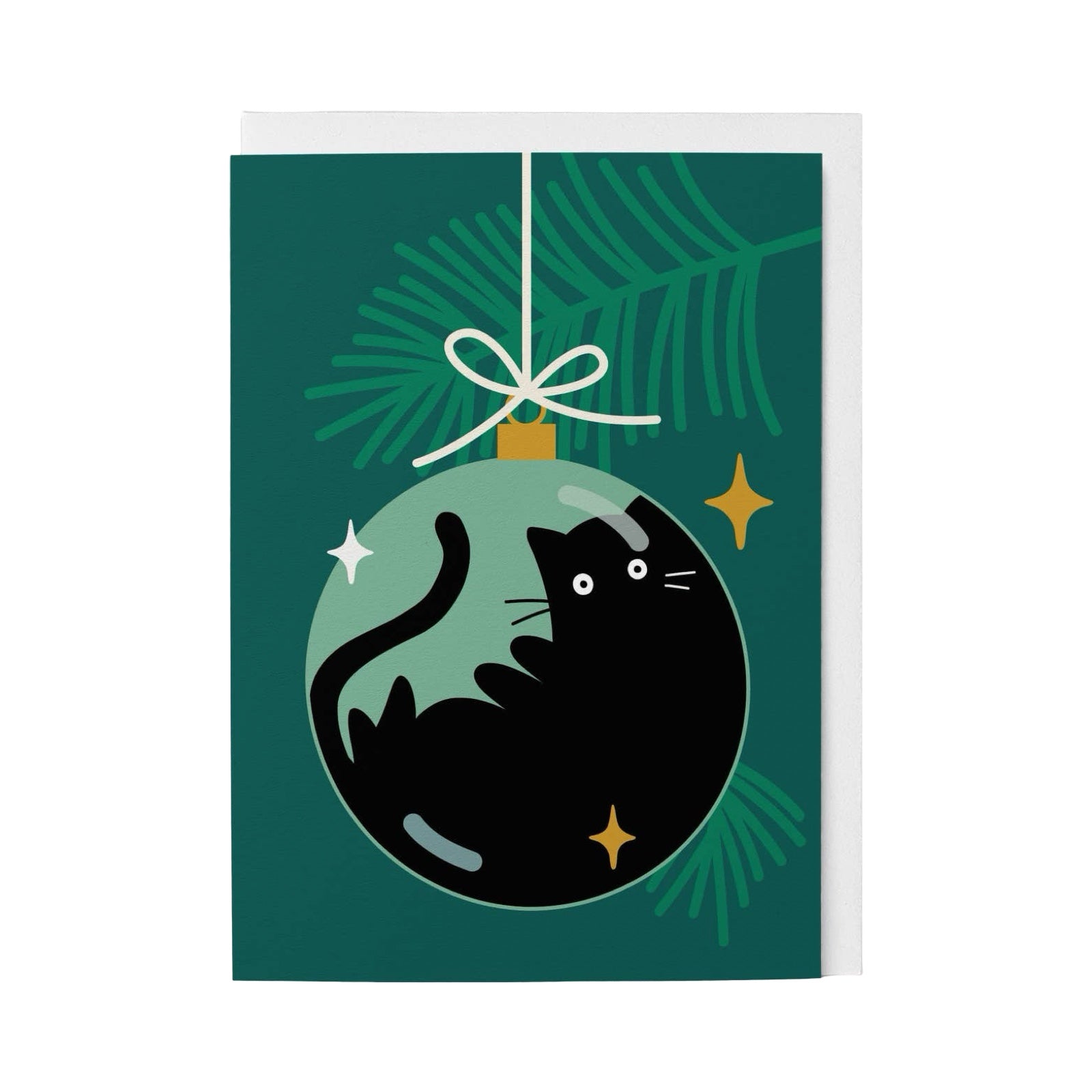 A Christmas greeting card featuring a black cat curled inside a green ornament, hanging against a dark green pine branch background with small gold stars.