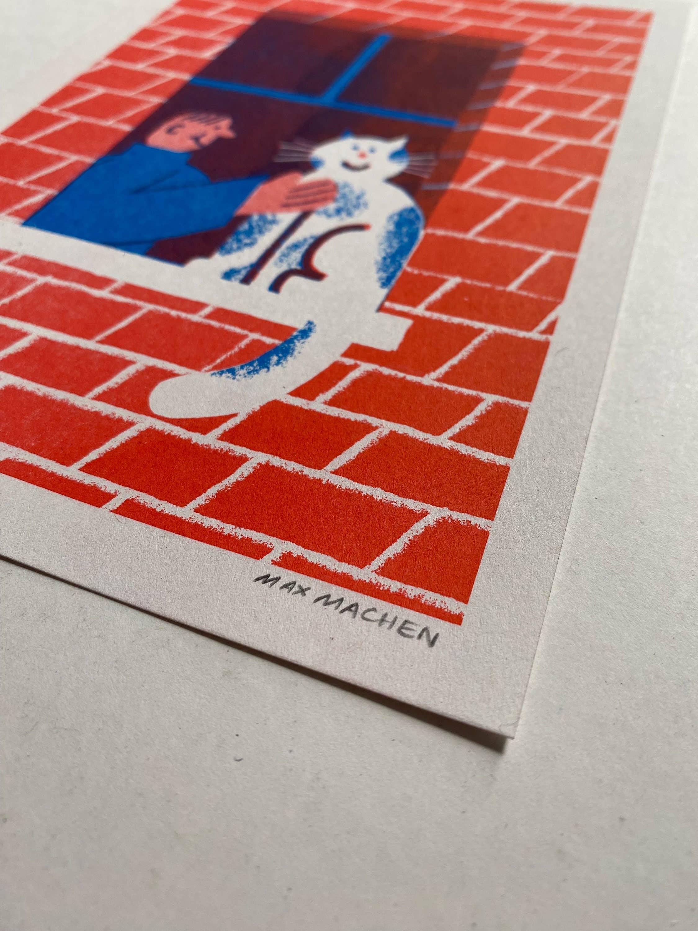 Illustration of a cat and person on a red brick wall with 'Max Machen' text.