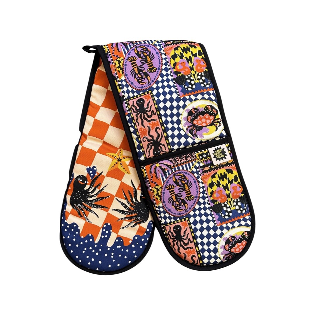 Oven gloves with a catch of the day print on one side and happy octopus on the reverse.