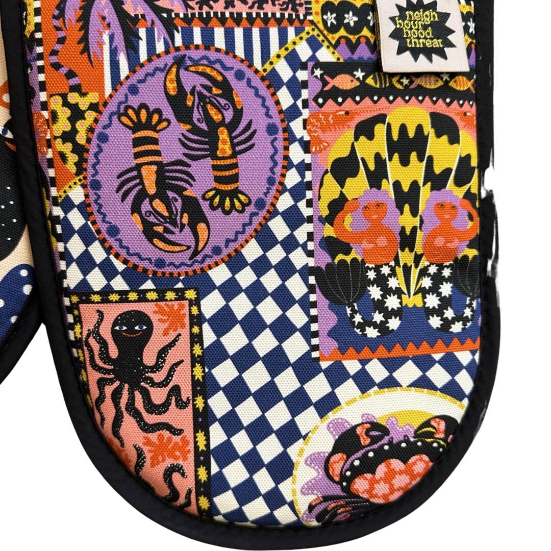 Catch of the day oven gloves featuring lobsters, mermaids and crabs.