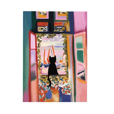 Cat card featuring a black cat sitting in the window of a colourful apartment. 
