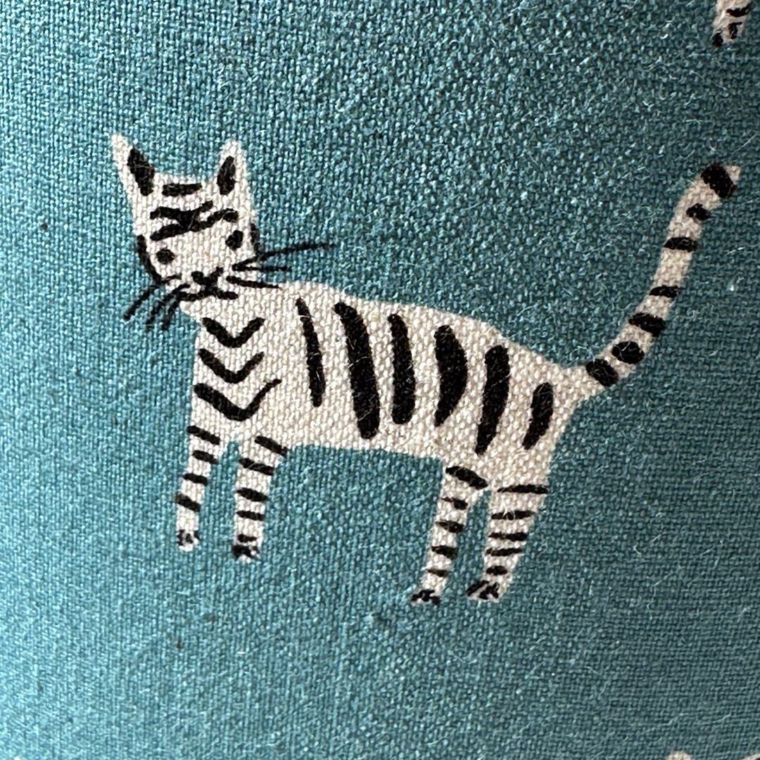 Blue fabric with a black and white cat