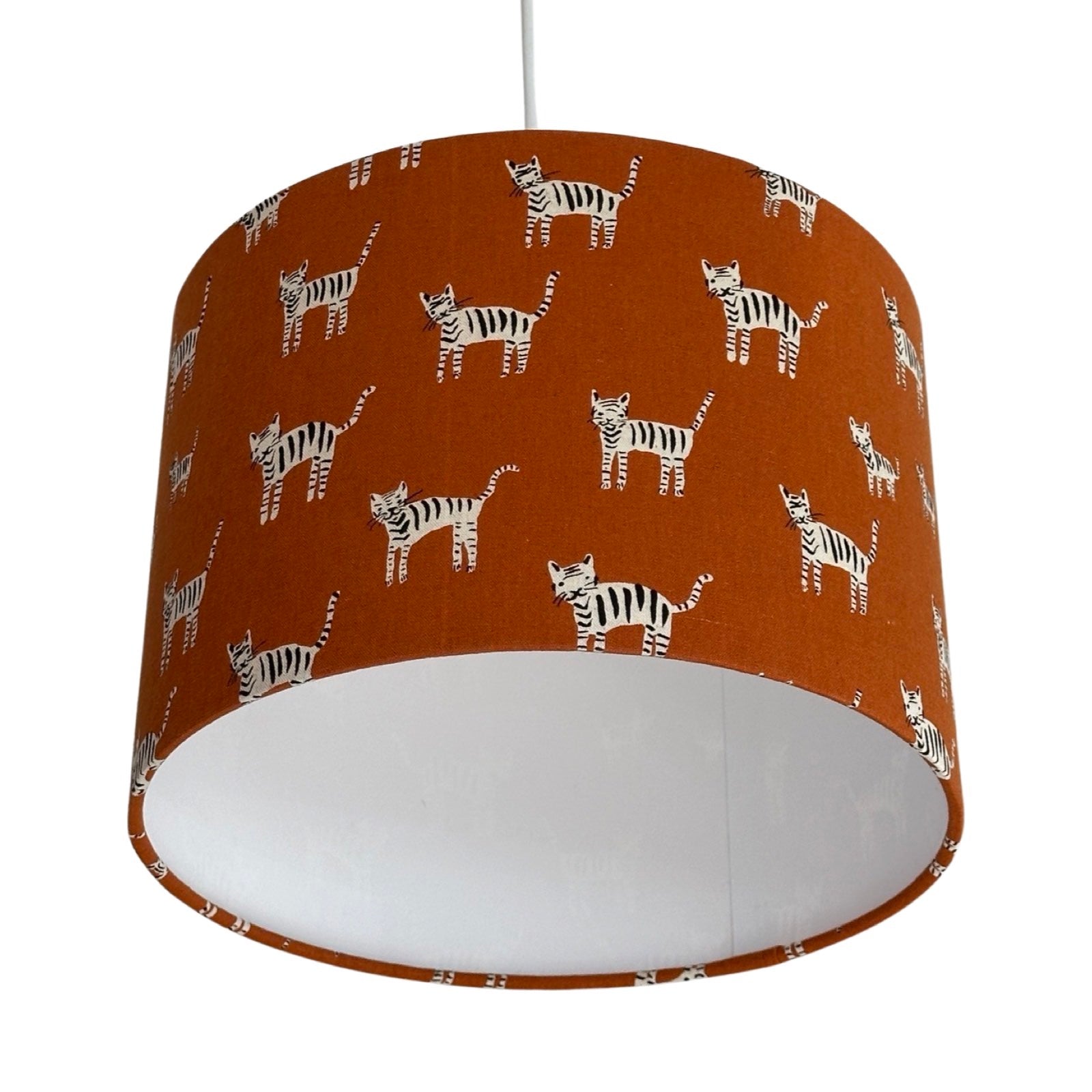 drum lampshade featuring black and white cats in different shapes and sizes on a mustard background