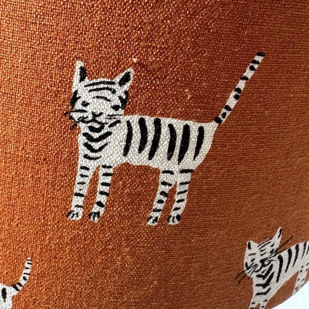 Mustard fabric with a hand drawn black and white cat