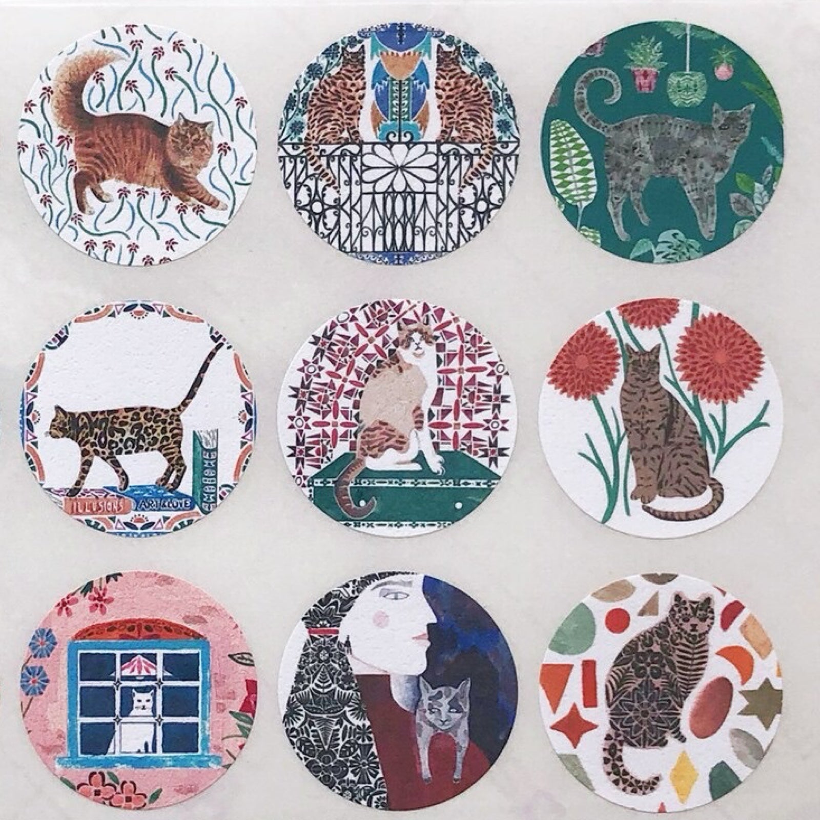 Set of circular stickers with cat illustrations on a white background.