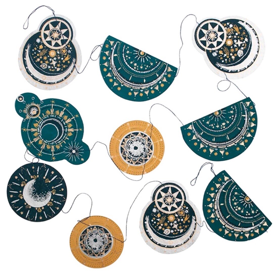 Celestial space garland, featuring ten screen printed paper moons and star constellations in various green, gold and black designs, 3m in length.