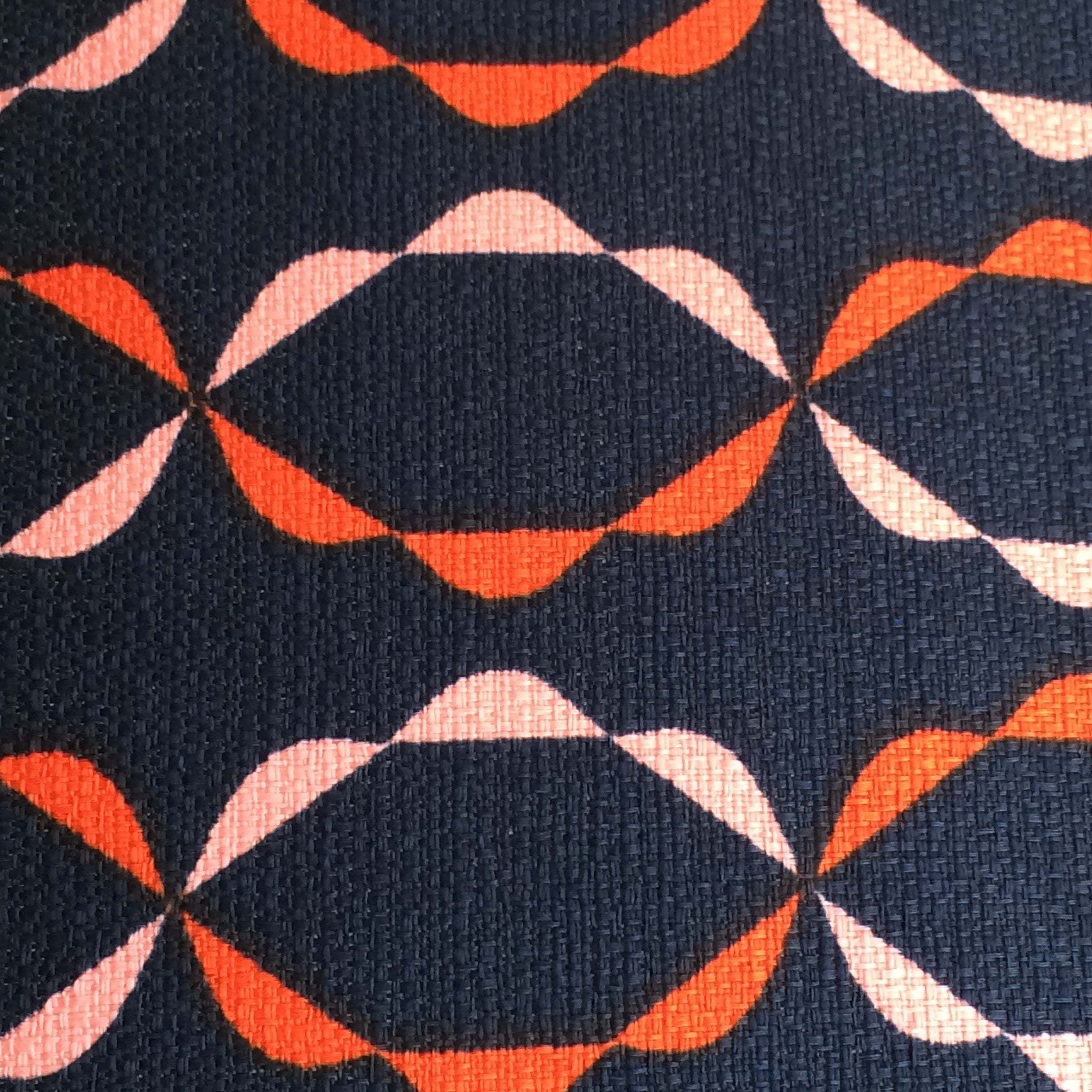 Navy barkcloth fabric with a red and pink chain pattern