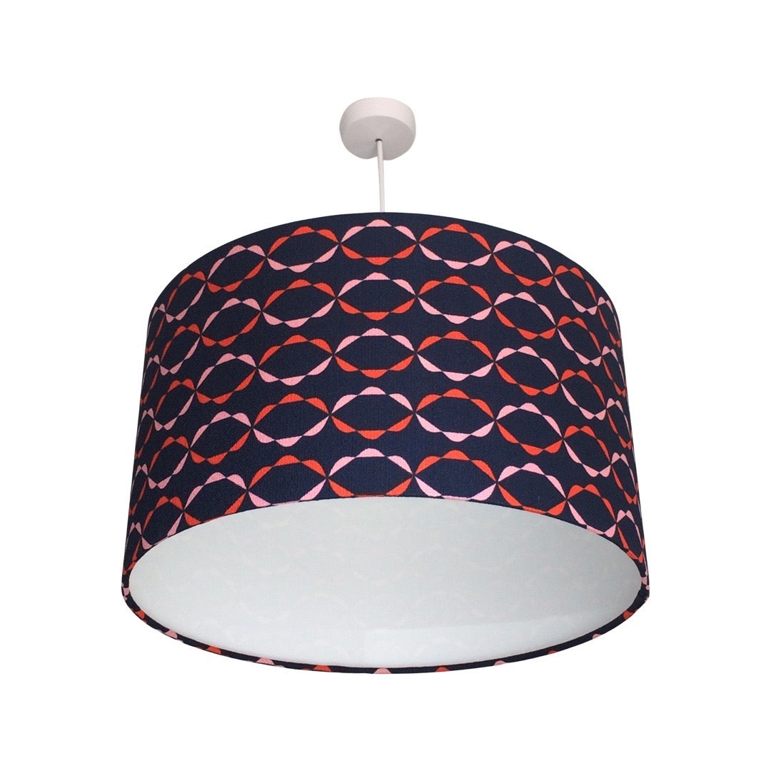 Navy barkcloth drum lampshade with a red and pink chain pattern