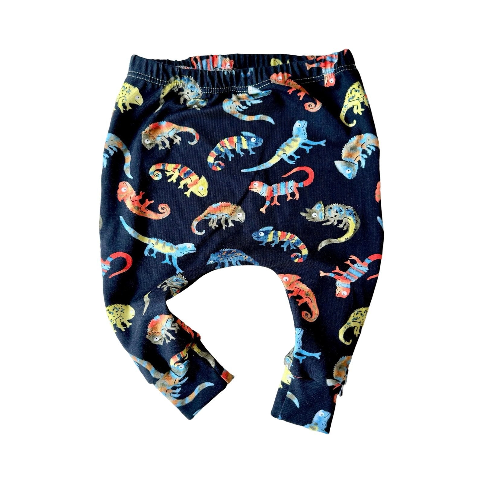 Navy cotton harem leggings with a pattern of colorful chameleons on the leg.