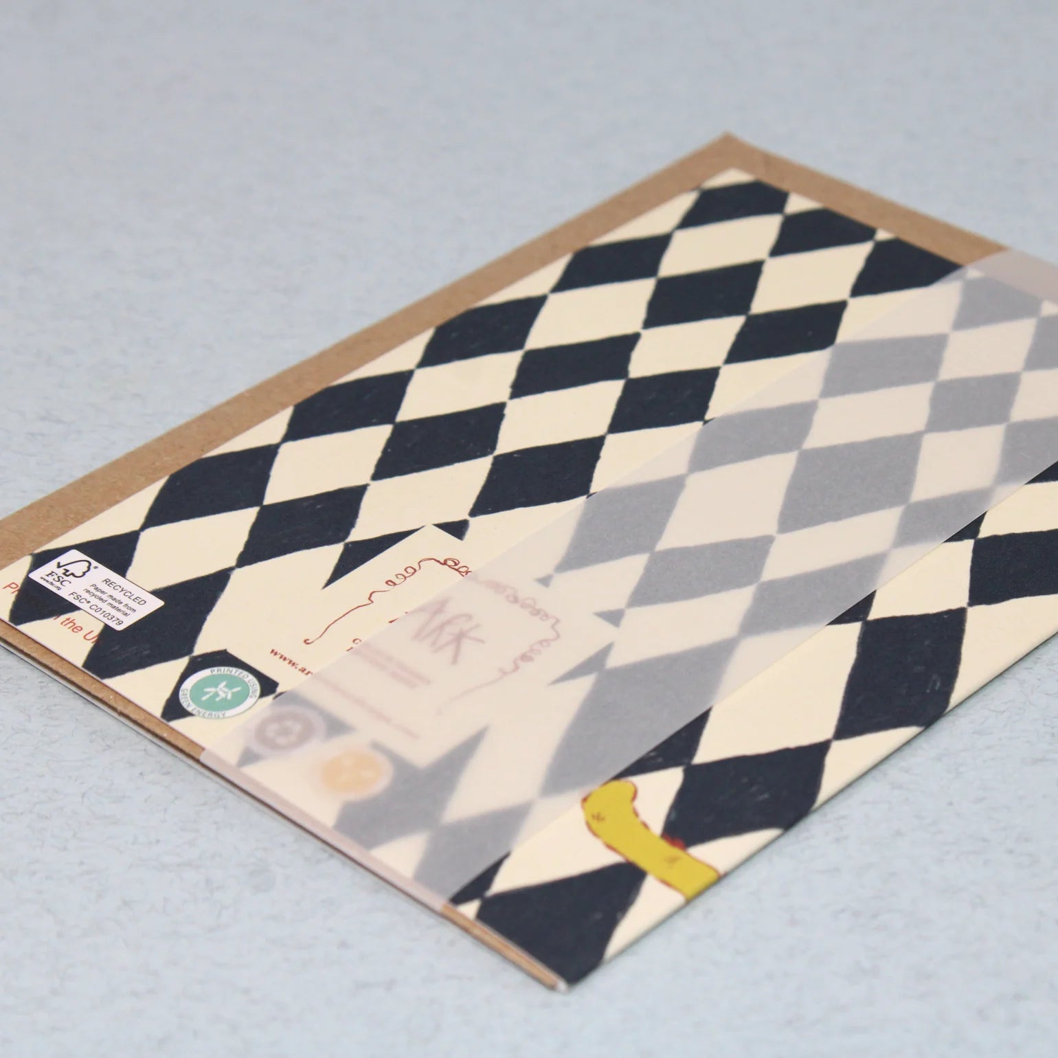 Checkered patterned card on a light grey background.