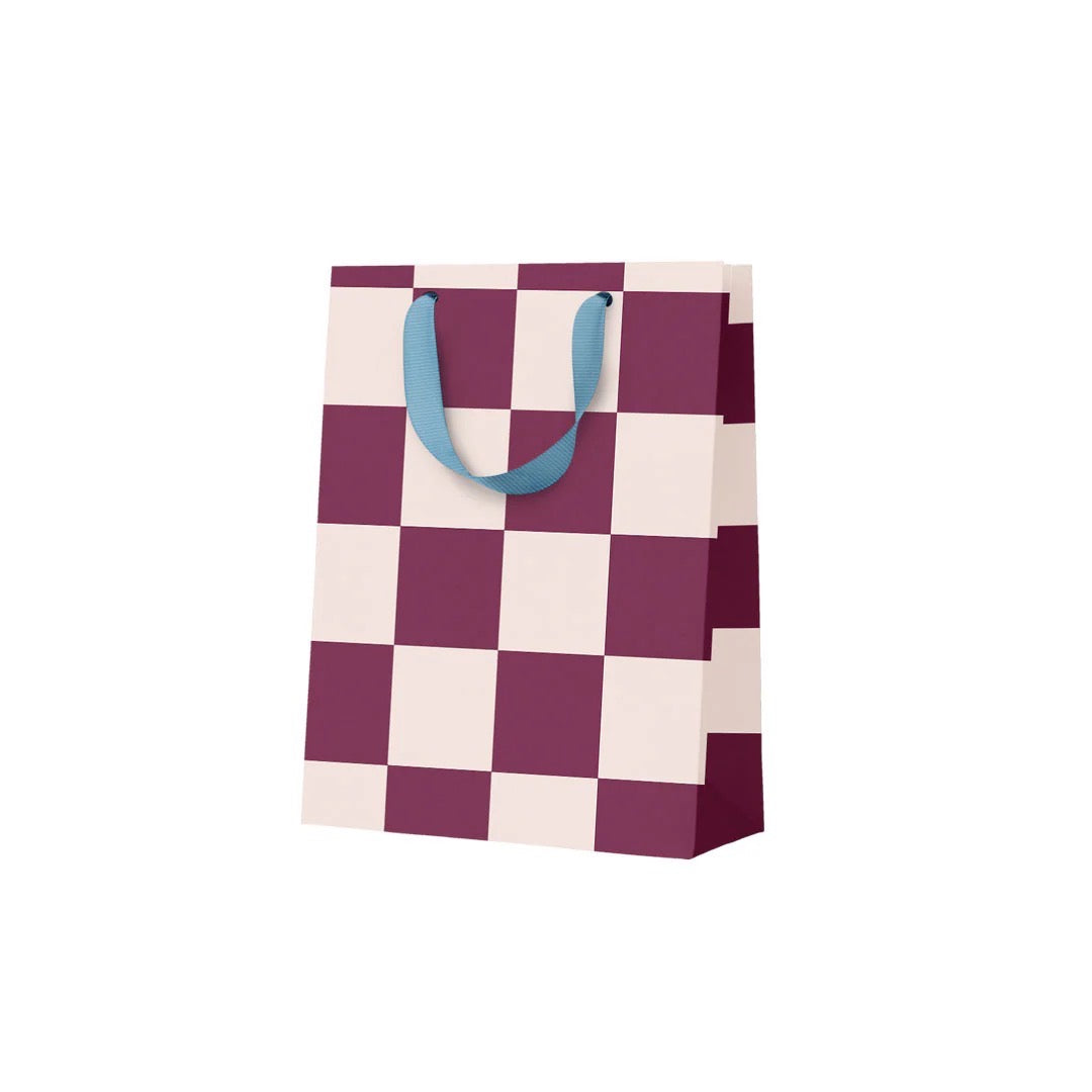 Checkered gift bag with blue handles on a white background.