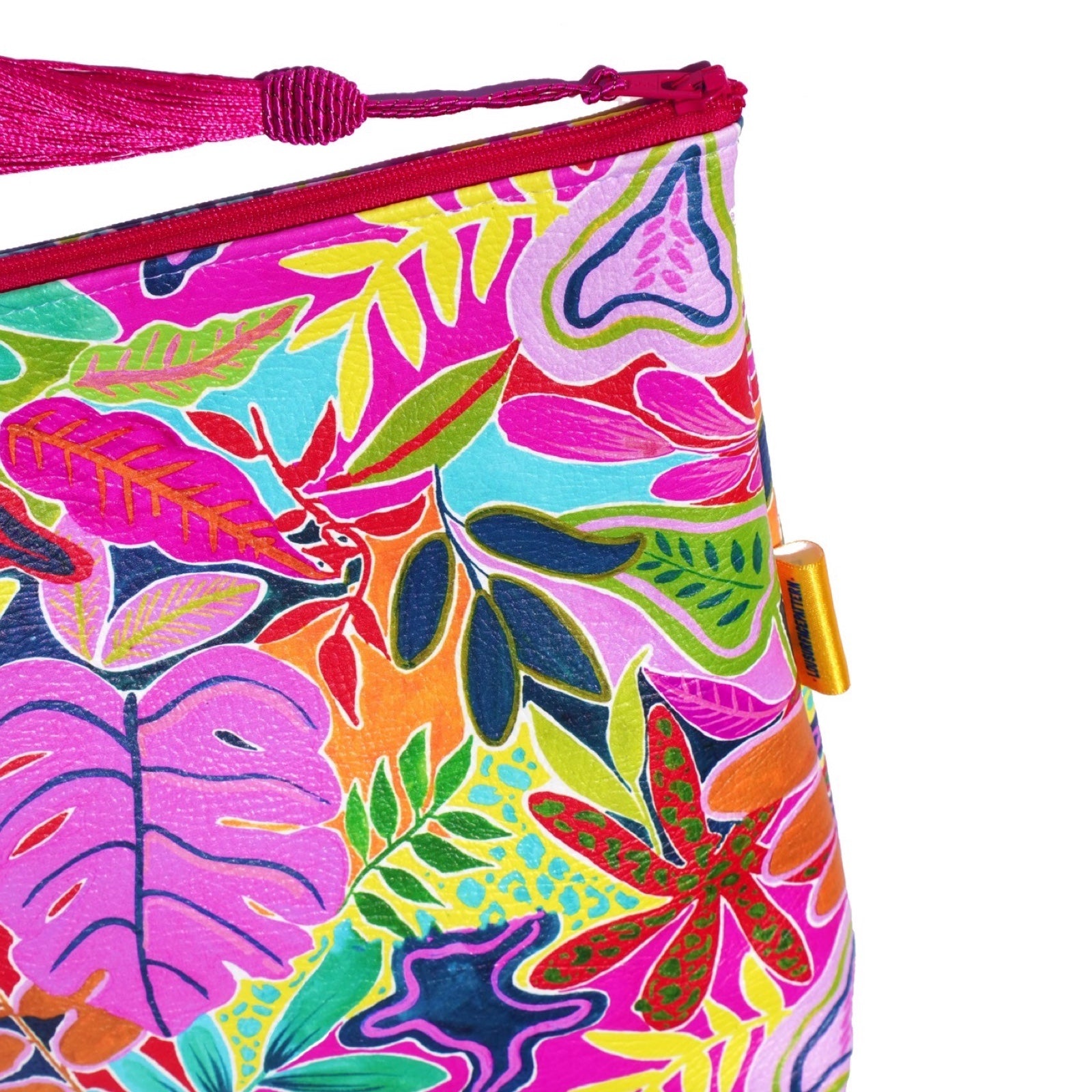 Vegan leather is printed in a bright and colourful tropical leaves design, and the bag is finished with a fabulous matching tassel on the end of the zip.
