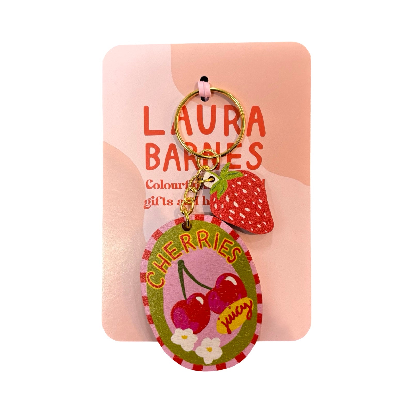 Keychain with cherry design on a pink card featuring 'Laura Barnes' branding.