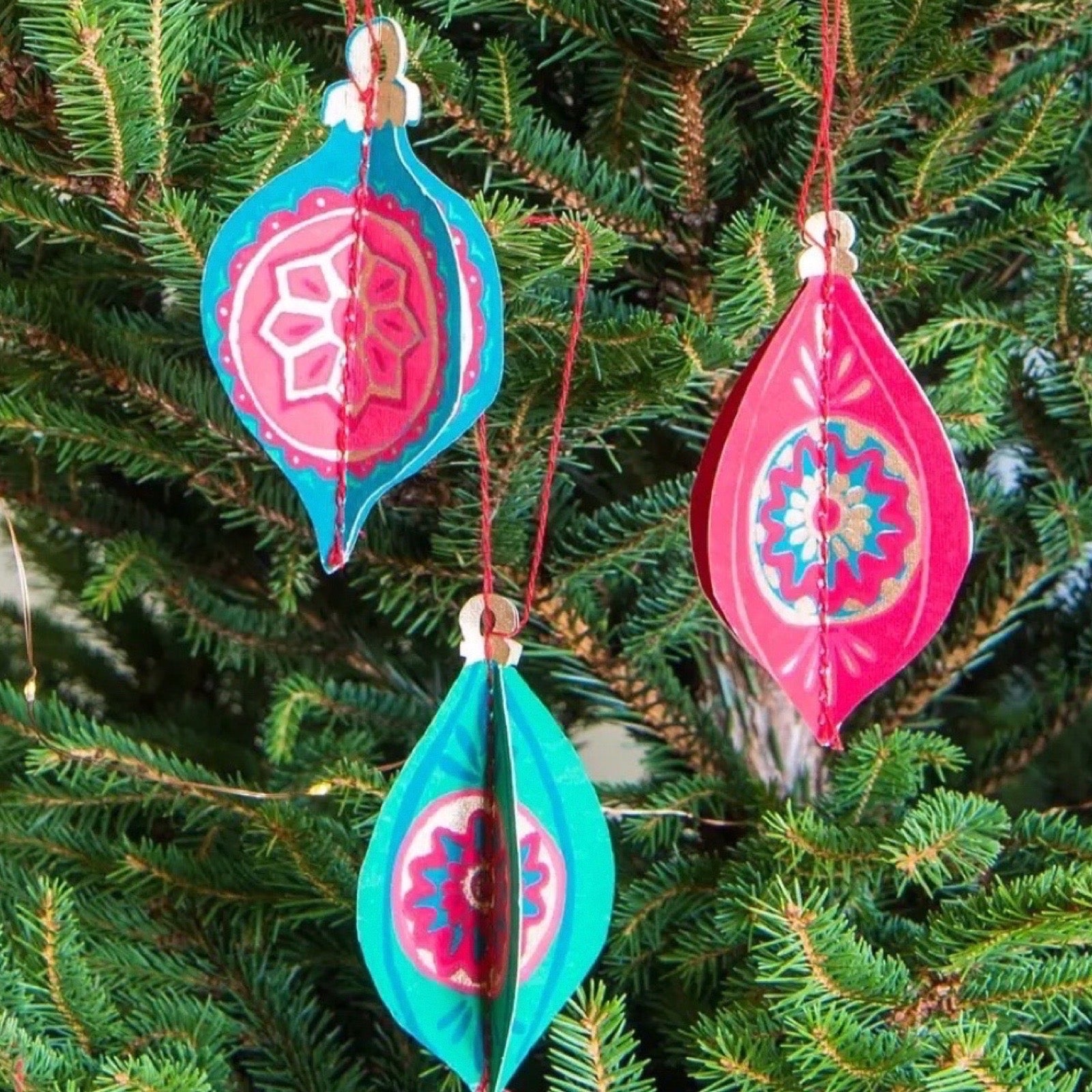 Decorative Christmas ornaments hanging on a tree.