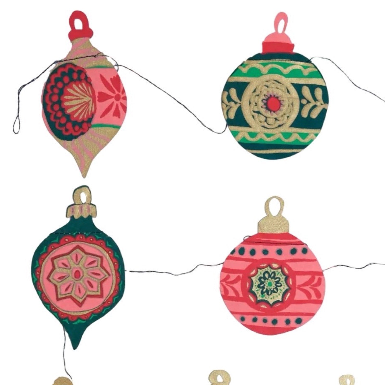 Decorative Christmas ornaments on a string with a white background.