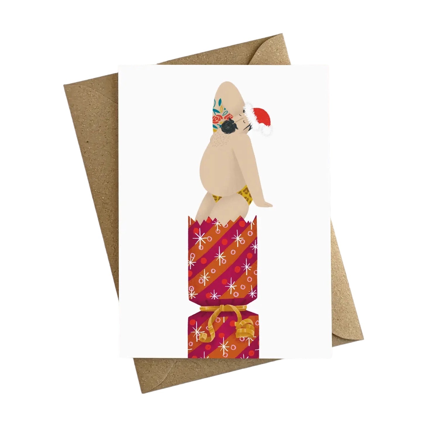 Christmas card featuring an illustration of a sexy, bearded, tattooed man in his leopard print swim trunks and a Santa hat, popping out of a gold and pink Christmas cracker.