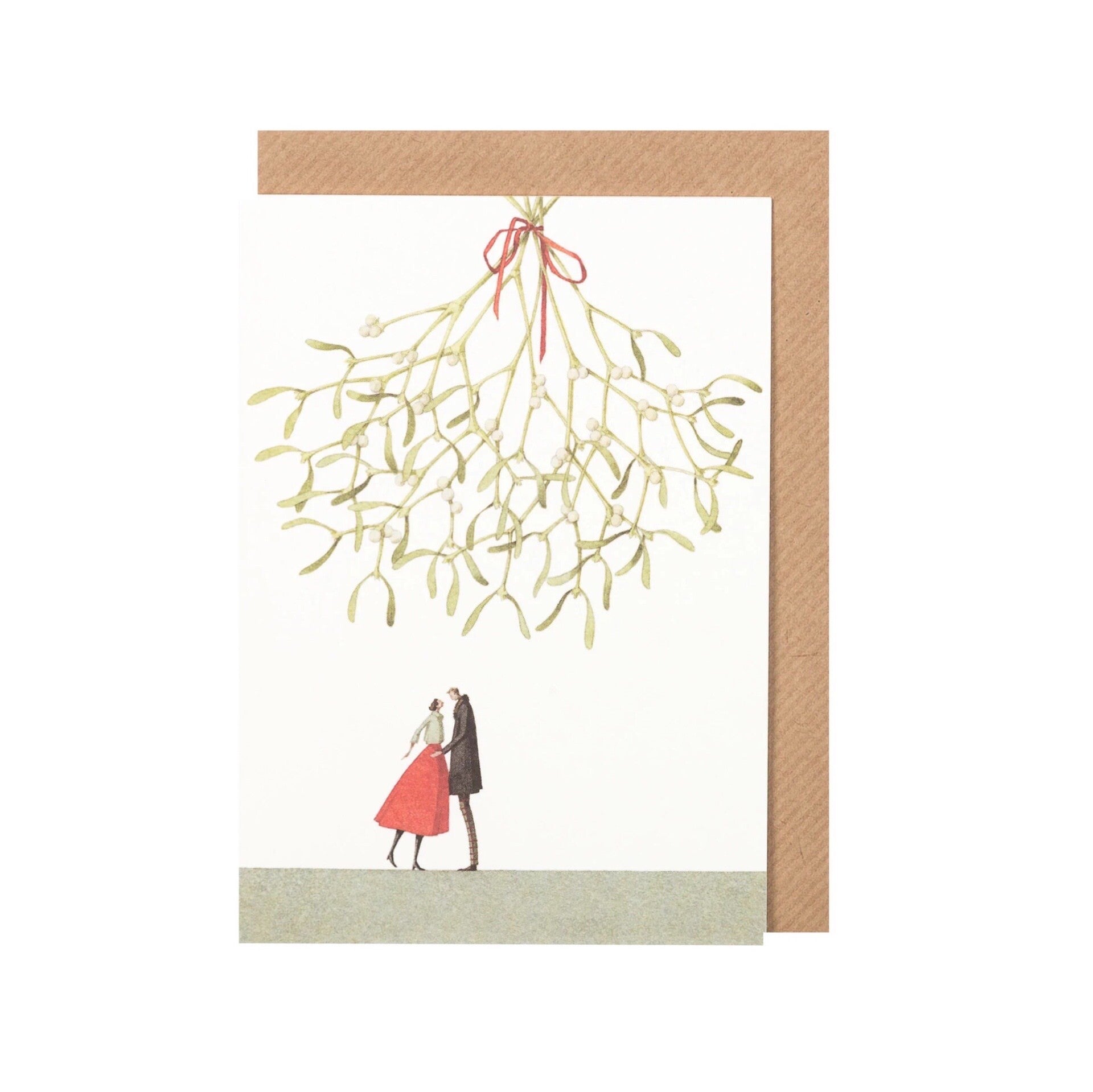 Christmas card featuring a lady in a red skirt and white shirt kissing a man in a black jacket underneath a giant bunch of mistletoe.