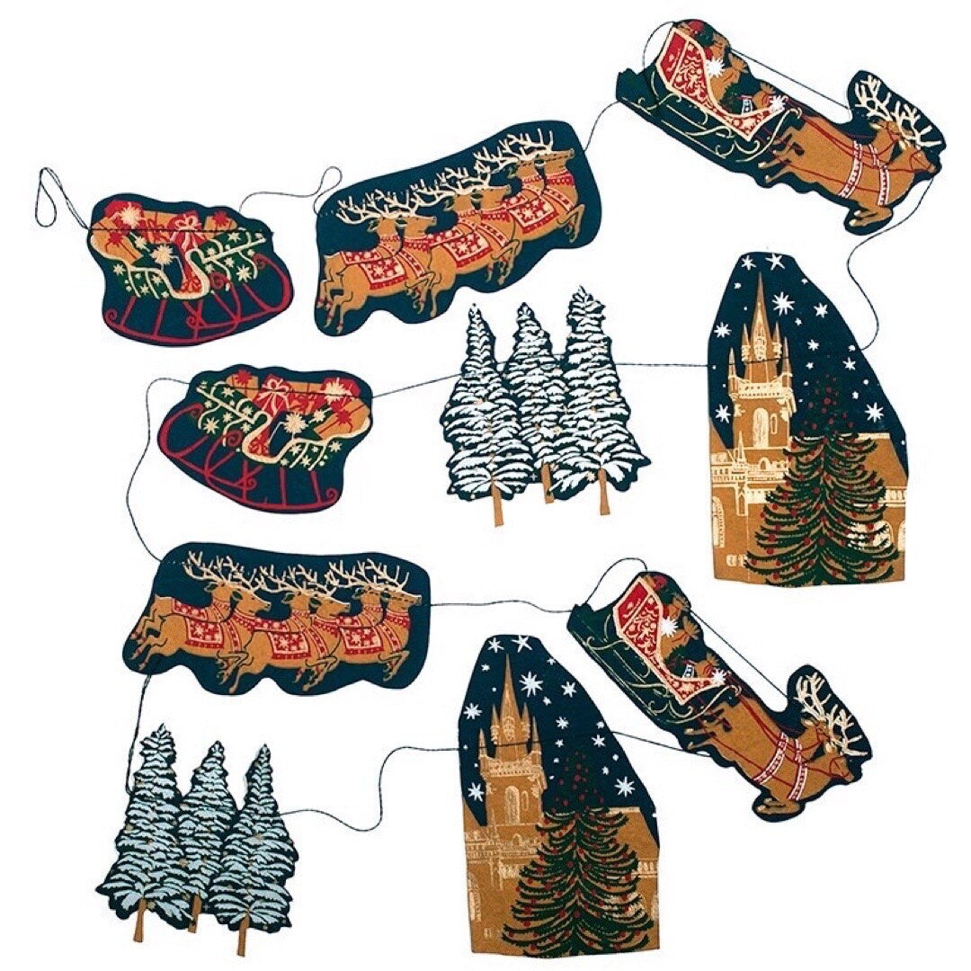 Christmas skyline garland, featuring ten screen printed paper sleighs, Christmas trees, flying reindeer and churches in the night sky in green, red, blue and gold.