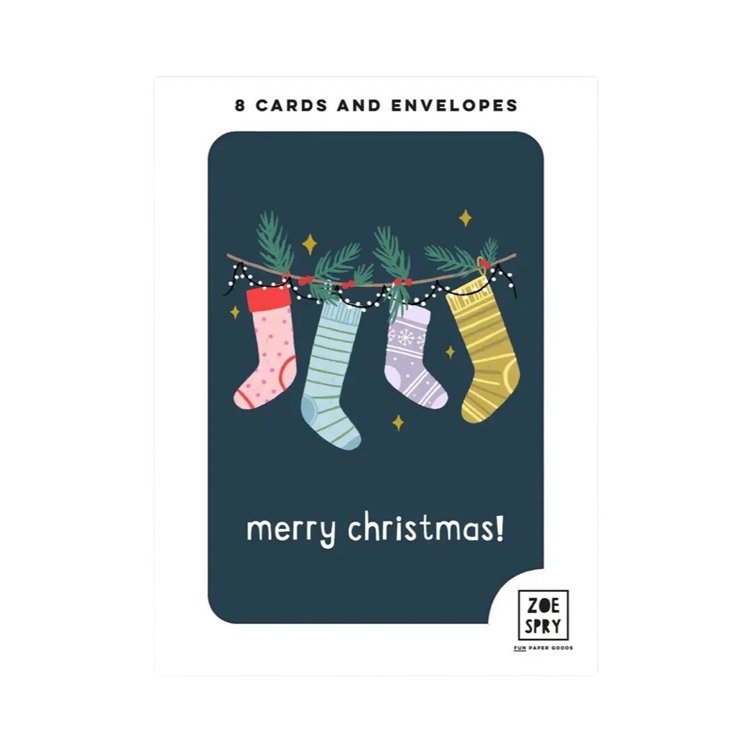 Pack of 8 Christmas stocking mini cards featuring an illustration of four hanging colourful Christmas stockings with holly inside them against a navy background and the text 'merry Christmas' written underneath in white.