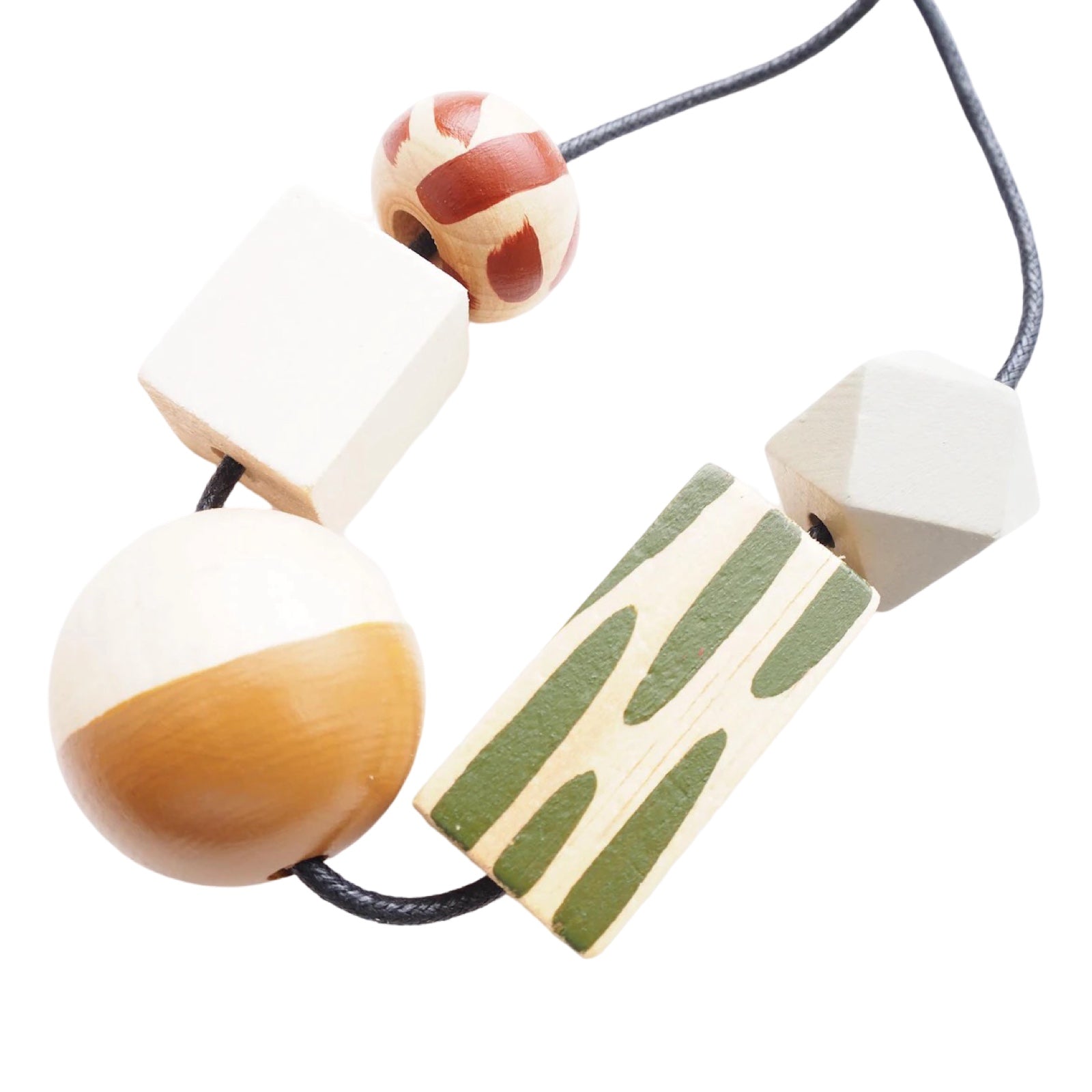 A chunky wooden necklace with 5 large colourful hand-painted beads, 1 with red dashes, 1 white cube, 1 mustard and white sphere, 1 rectangle with green dashes and 1 grey threaded on a black cotton cord with a silver-plated fastening.