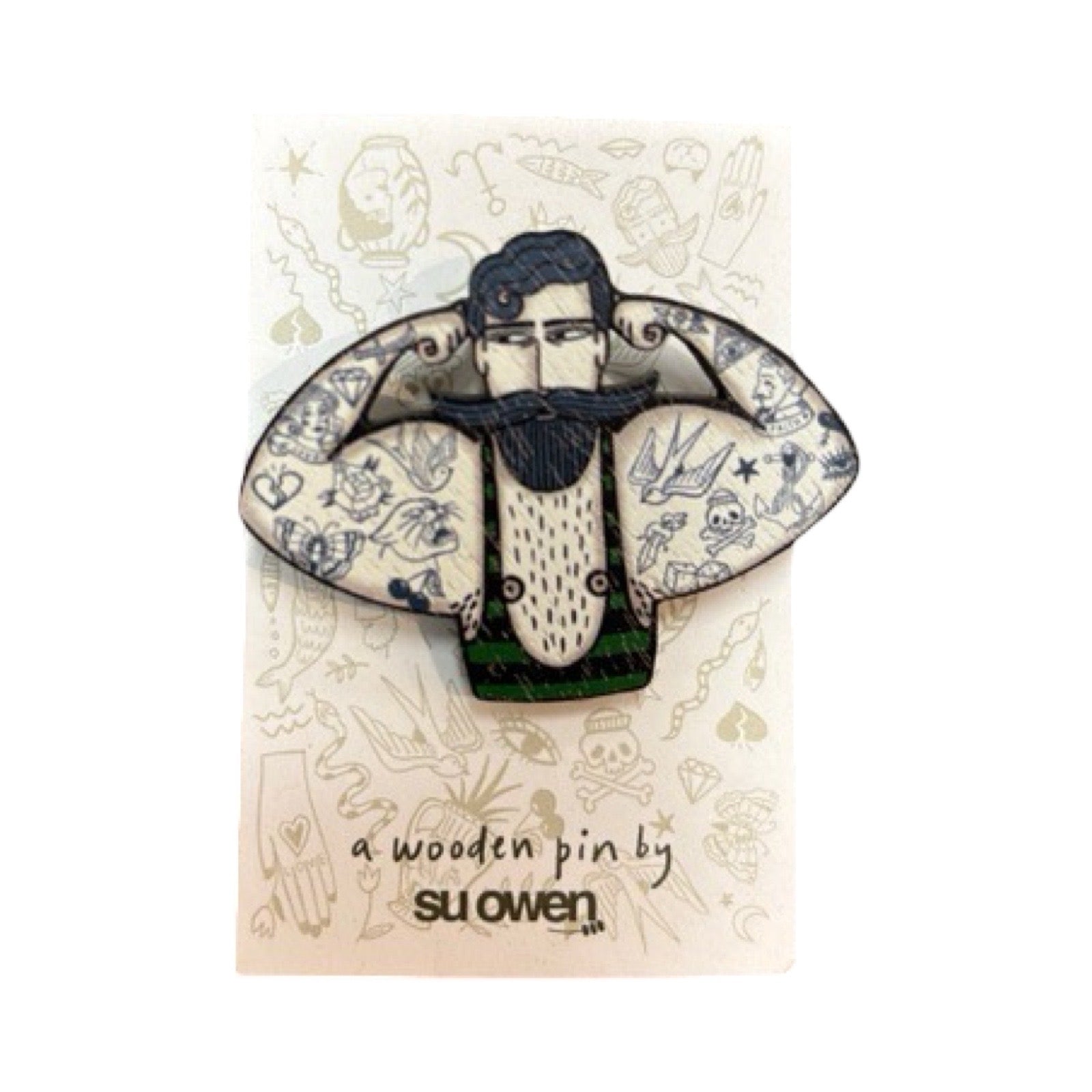 Circus Strongman wooden brooch featuring a tattooed, bearded strongman showing off his muscles.