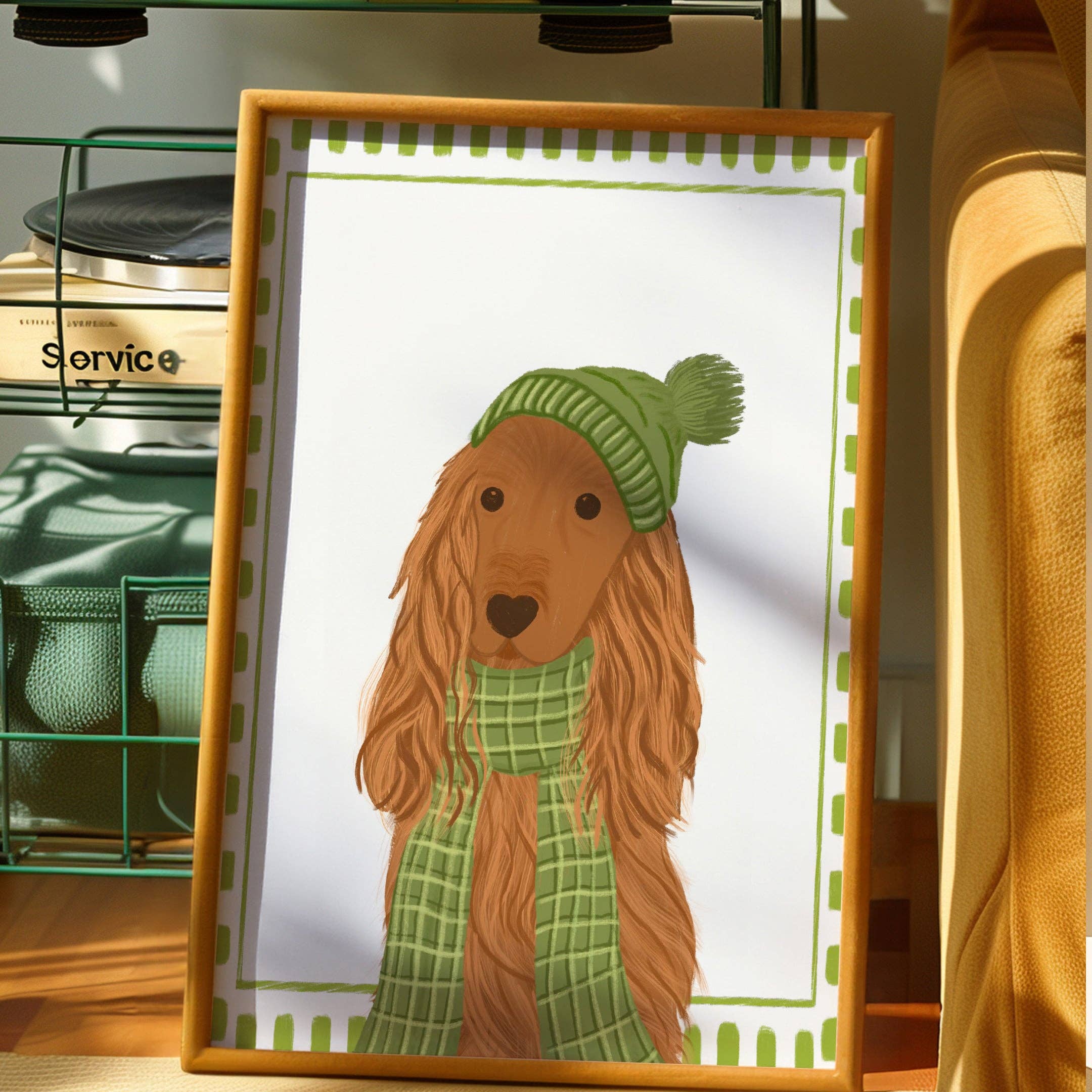 Framed illustration of a dog wearing a green hat and scarf on a white background.
