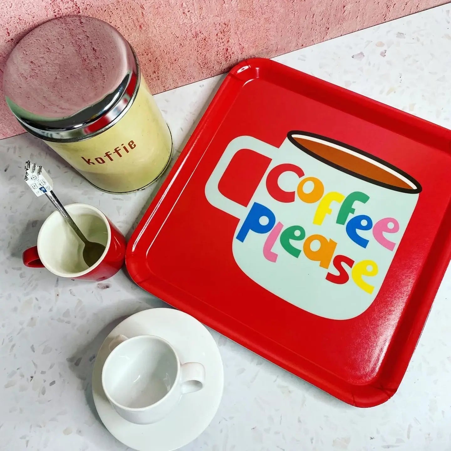Red tray with 'Coffee Please' design, mug, and thermos on a light surface.