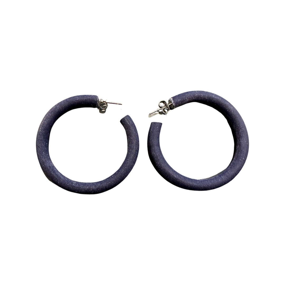 A pair of large navy hoop earrings made from polymer clay, displayed against a white background.