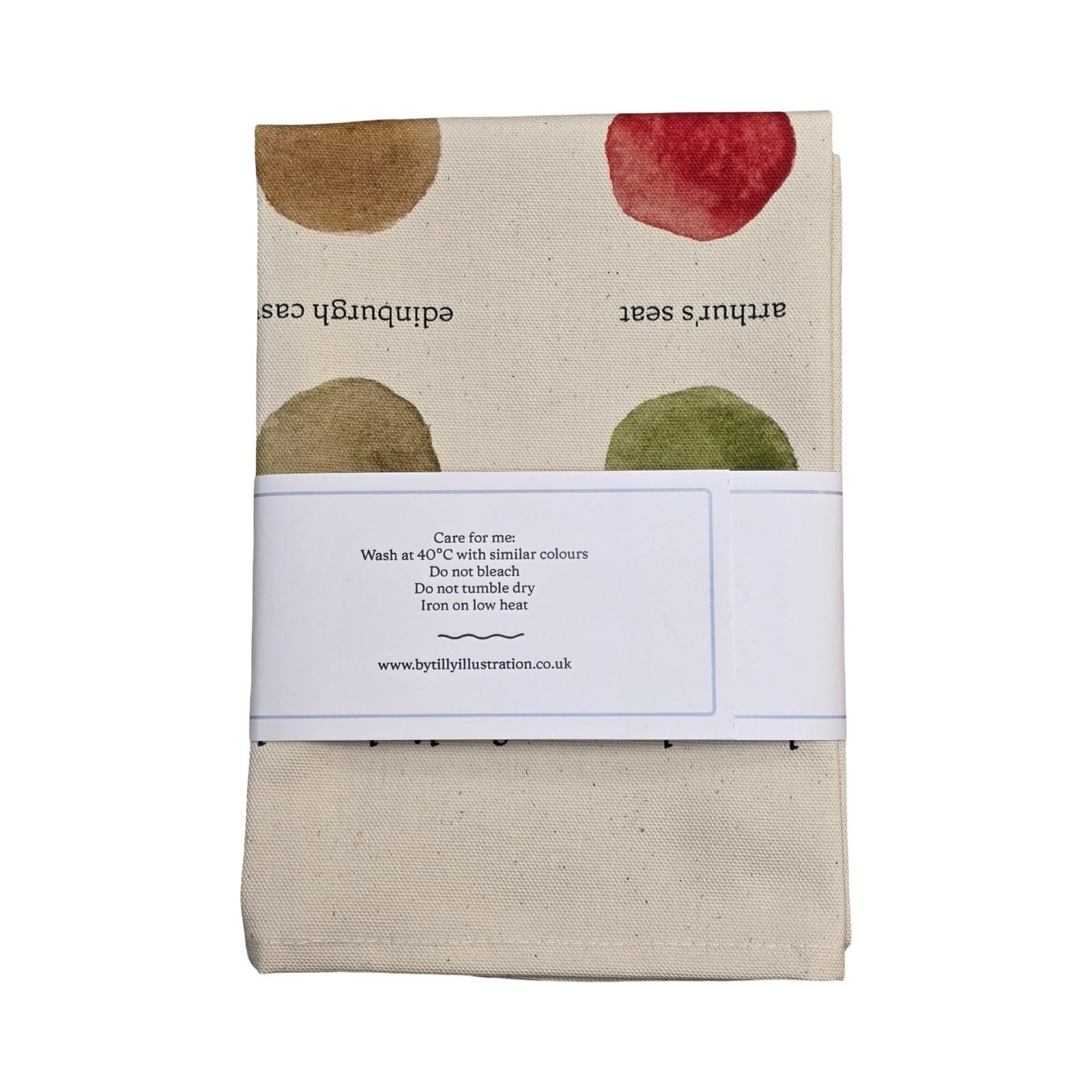 Folded fabric with circular patterns and text on a white background.
