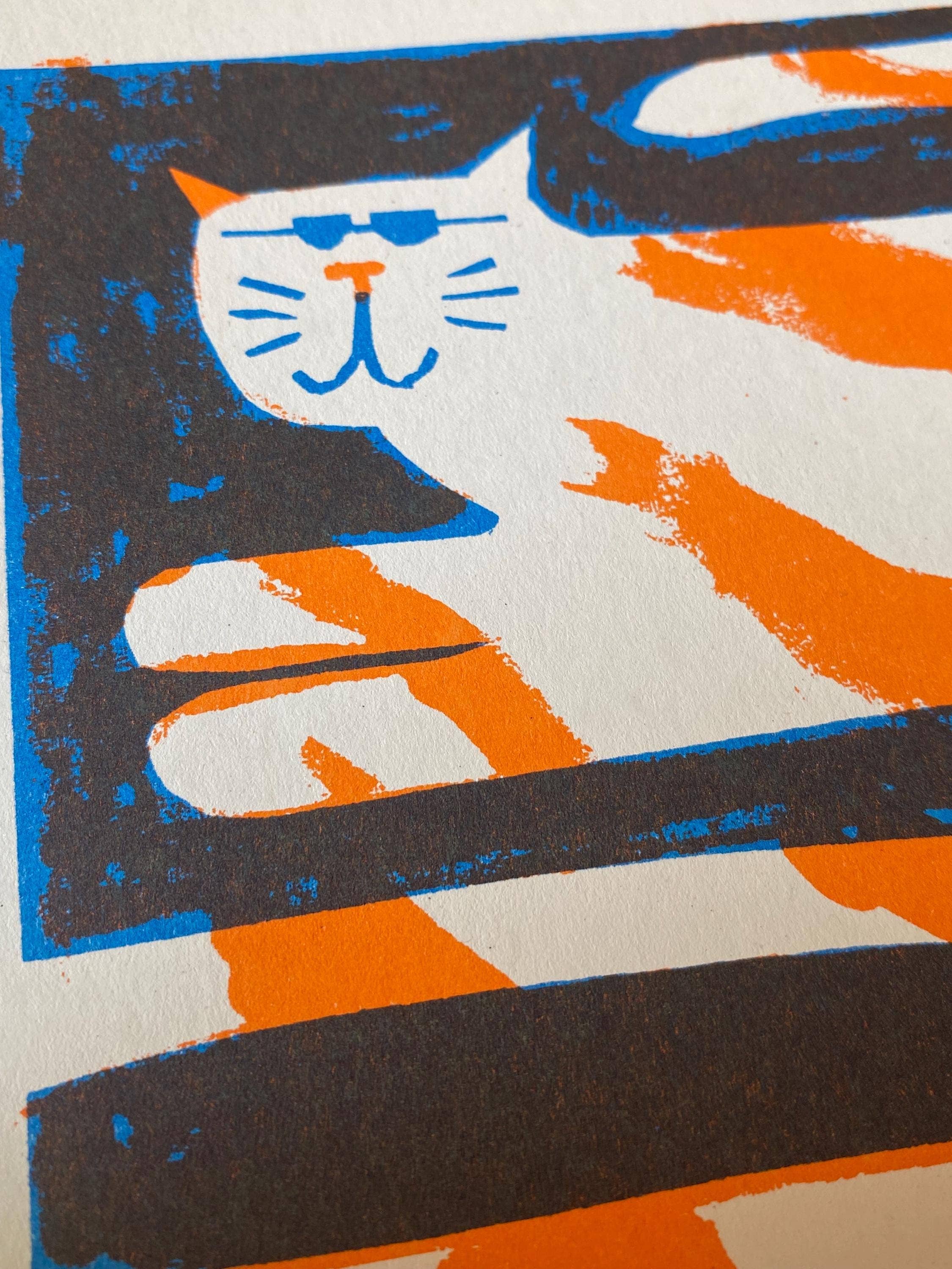 Two-colour risograph print featuring a ginger and white cat, against a black background.